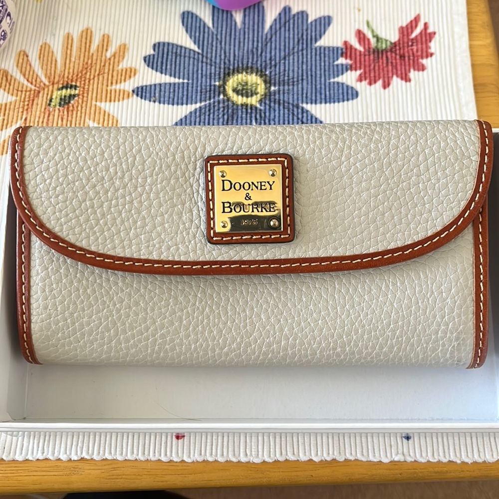 Dooney & Burke wallet with 8 card slots, checkbook slot, and coin pouch on back.